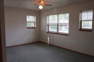 Image of space with several windows and overhead fan